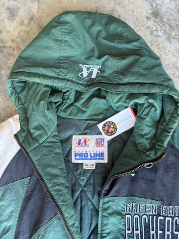 An olive green and dark gray quilted jacket with a zippered front, featuring a Pro Line tag and a white embroidered logo on the shoulder, laid flat on a concrete floor.